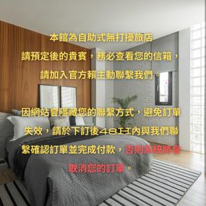a room with a bed and a wall with writing on it at H suite Go in Changhua City