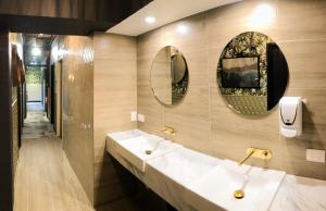 a bathroom with two sinks and two mirrors on the wall at Brisbane Quarters in Brisbane