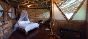 Postel nebo postele na pokoji v ubytování Ecohotel Soplo del Tambo