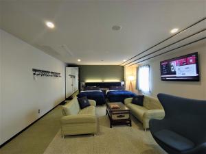 a large living room with a couch and a tv at Green Rich Hotel Matsue Station Across - Artificial hot spring Futamata Yunohana in Matsue