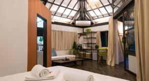 a room with a bed and a living room at kawayan villa siargao in General Luna
