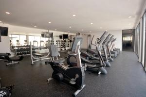 a gym with a bunch of tread machines in it at IPANA Luxury Apartments by Vacaciones.Yeah in Playa del Carmen