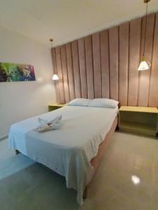 two birds sitting on a bed in a bedroom at Hotel Kasvel in Valledupar