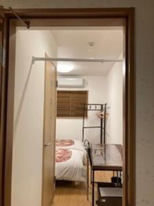 a bedroom with a bunk bed and a table at Echigo Yuzawa Hirokawa in Yuzawa