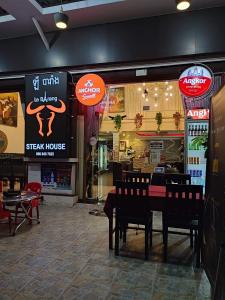 a steak house restaurant with a table and chairs at Le Barang Steakhouse & Guesthouse in Sihanoukville