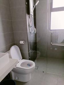 a bathroom with a shower and a toilet and a sink at The CLIO 2 residences, beside ioi city mall, opposite hospital Serdang, beside Uniteen and UPM, Putrajaya in Putrajaya