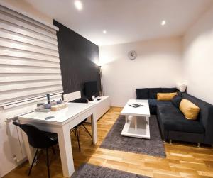 a living room with a couch and a table at Stan na dan Nina - Pale Centar in Pale