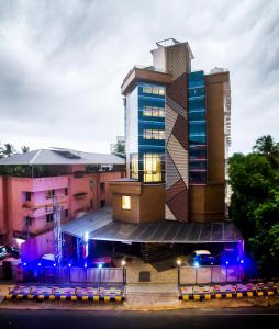 a building with blue lights in front of it at Hotel Guruvayur Darshan in Guruvāyūr