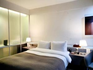 Ένα ή περισσότερα κρεβάτια σε δωμάτιο στο JS Boutique Hotel