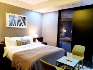 Ένα ή περισσότερα κρεβάτια σε δωμάτιο στο JS Boutique Hotel