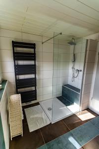 a bathroom with a shower with a glass enclosure at Timeout Namaste in Ellar