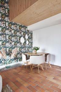 a dining room with a table and chairs at La Suite in Chiroubles +13 photos