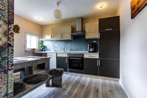 a kitchen with a black refrigerator and a counter at Timeout Namaste in Ellar