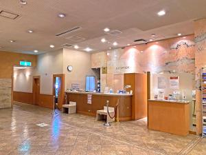 a lobby of a hospital with a waiting room and a counter at Hotel Pearl City Sapporo in Sapporo