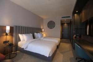 a hotel room with a large bed and a television at Crowne Plaza Ankara, an IHG Hotel in Ankara