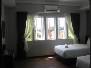 Postel nebo postele na pokoji v ubytování 707 Hotel (Cheng Ho ) Melaka