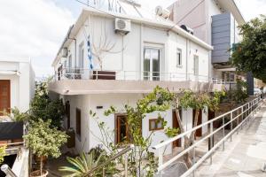a white house with a balcony at Eris House in Kissamos