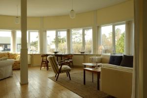 a living room with a couch and a table at Hotel Strandlyst Badehotel in Hirtshals