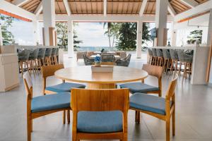 a dining room with a table and chairs at Tahuna Beach Hotel and Resort in Taruna