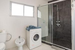 a bathroom with a shower and a washing machine at Charming flat in puerto Marina, Benalmadena in Benalmádena +18 photos