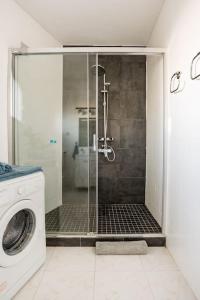 a shower in a bathroom with a washing machine at Charming flat in puerto Marina, Benalmadena in Benalmádena