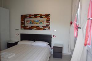 A bed or beds in a room at Le Stanze di Bacco