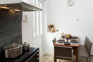 a kitchen with a stove with pots and pans on it at ERIS House in Kissamos