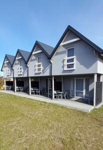 a large house with a lawn in front of it at Poprzeczna 7 in Sarbinowo