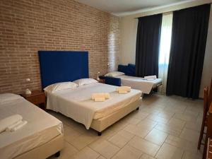 Ένα ή περισσότερα κρεβάτια σε δωμάτιο στο Hotel Adriatico