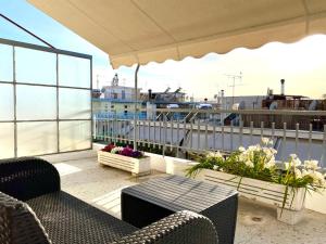 a balcony with a table and chairs and a ship at Charming flat with an amazing view in Athens