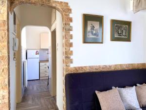 a room with a blue headboard and a kitchen at Charming flat with an amazing view in Athens
