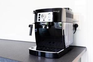 a black coffee maker sitting on a counter at Großzügiges Ferienhaus in ruhiger Lage in Würzburg