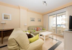 a living room with a couch and a table at Apartamento 363 in Marbella