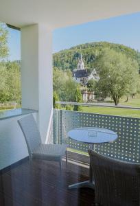 a patio with a table and chairs on a balcony at Züfle Hotel Restaurant Spa in Sulz am Neckar