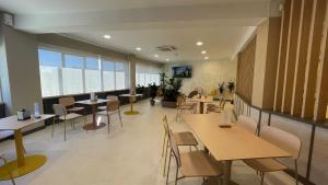 a restaurant with tables and chairs and a large window at Hotel Restaurante Cadosa in Soria