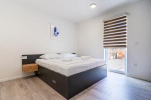 1 dormitorio con 1 cama grande con sábanas blancas en Blue Sorbeto, en Cres