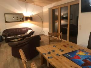 a living room with a table and a couch at Ferienwohnung NaturZeit in Sankt Englmar