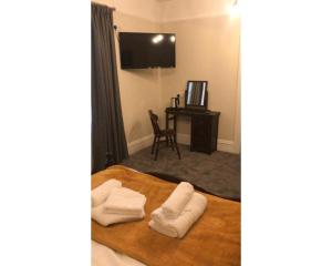 a hotel room with two towels on a bed at The Red Lion Hotel in Chester-le-Street