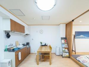 a kitchen with a table in a room at HOSTEL PAQ tokushima / Vacation STAY 35580 in Tokushima