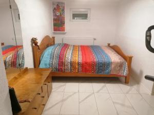 a bedroom with a bed and a wooden table at Schöne Einliegerwohnung in Hechingen in Hechingen