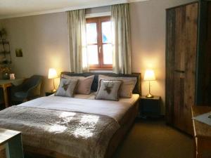 a bedroom with a bed with two lamps and a window at Haus Louise in Reit im Winkl