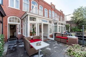 a patio with two chairs and a table in front of a building at Studio Loren / Studio Fellini in Zandvoort