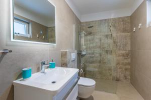 a bathroom with a sink and a toilet and a shower at Apartment Blue Monstéra in Cres +11 photos