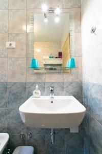 a bathroom with a sink and a mirror at APARTMA JANJA in Bovec