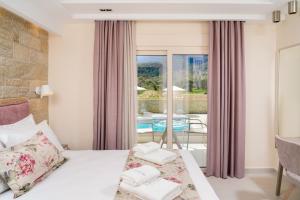 a hotel room with a bed and a balcony at Supreme Luxury Suites in Skala Potamias +57 photos