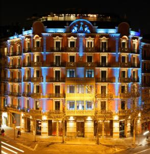 a large building with a clock on the front of it at Cram Hotel in Barcelona