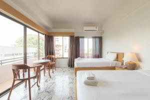 Postel nebo postele na pokoji v ubytování Nonthaburi Palace Hotel