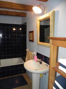 a bathroom with a sink and a mirror and a tub at BAIX EMPORDÀ. Increíble casa en pueblo medieval in Cruïlles