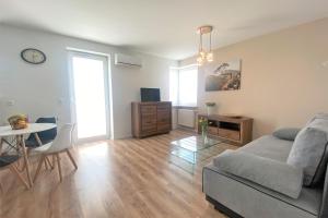 a living room with a couch and a table at Apartament Solaris in Mielec