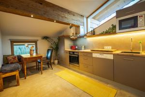 a kitchen with a table and a dining room at Bio Yoga Hof Kitzbühel in Kitzbühel